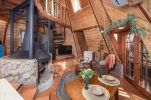 a living room with a fireplace in a log cabin at Halfling House w/hot tub/firepit/more! in Coarsegold