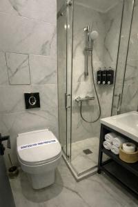 a bathroom with a shower and a toilet and a sink at Raya Boutique in Sunny Beach +16 photos