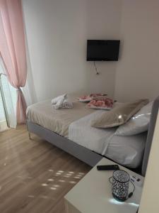 a bedroom with a bed with a tv on the wall at locazione turistica da Iole in Popoli