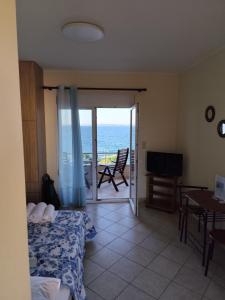 a bedroom with a bed and a view of the ocean at GEOMELOS Georgios APARTMENTS CHIOS in Chios