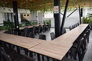 a row of tables in a room with chairs at Hotel Brisas De Calima in Cali