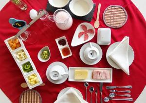 a table with plates of food on a red table cloth at Apalta Vista Wine Lodge in Estación Santa Cruz