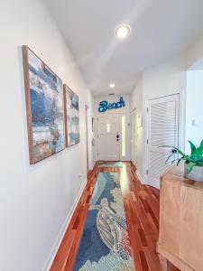 a hallway with white walls and a blue sign on the wall at 3017 Ocean Winds in Seabrook Island