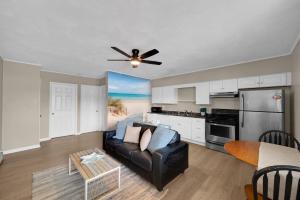 a living room with a couch and a ceiling fan at Between Tides 2BR Walk to Beach Unit B in Seaside Park +14 photos