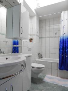 a white bathroom with a toilet and a sink at Guest House Frane in Pag +77 photos