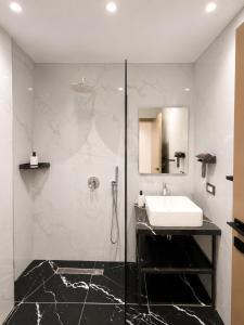 a bathroom with a sink and a shower at Blester Hotel Golem Durres in Golem +43 photos