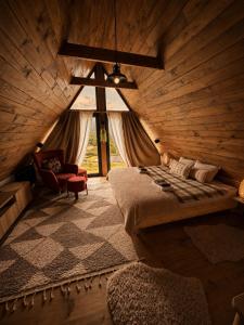 a bedroom with a bed in a wooden room at Grzeszne Chatki - Smerek in Smerek