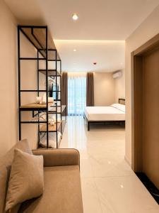a living room with a couch and a bed at Blester Hotel Golem Durres in Golem