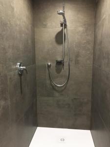 a shower with a hose in a bathroom at Berghoamat Nauders in Nauders