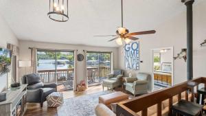 a living room with a couch and a ceiling fan at Honey Hole 3 Well Dock in Camdenton