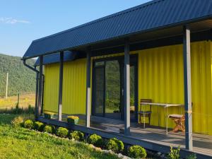 a yellow house with a black roof at ILLU Resort in Orhei