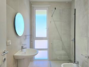 a white bathroom with a sink and a shower at Azure Garden Villa 317 in Lalzit Bay +22 photos