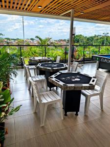 a group of tables and chairs on a patio at Hotel Brisas De Calima in Cali