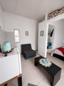 a living room with a couch and a chair at Alojamiento EYO en Chuy con Baño Privado y Aire Acondicionado in Chuy