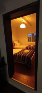 a mirror reflection of a bed in a bedroom at Villa Visconde in Nordeste