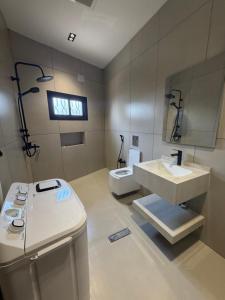 a bathroom with a sink and a toilet at شقق الحصن الفاخره in Al Baha