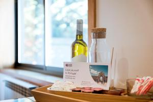 a wooden tray with a bottle of wine and cheese at GuestReady - Seaside Experience in Moledo in Moledo