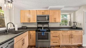 a kitchen with wooden cabinets and a stove top oven at Honey Hole 3 Well Dock in Camdenton