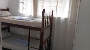 a bunk bed in a room with a window at Casa da Floresta in Vitória