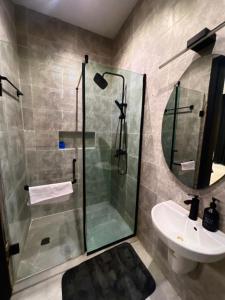a bathroom with a shower and a sink at Fa Apartment in Lekki
