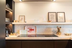 a kitchen with a counter with some framed pictures at The Strand Agency - June in Cadzand-Bad