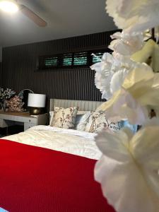 a bedroom with a bed with white sheets and pillows at Tree Top & Bluebell Cottages in Grange Road Station