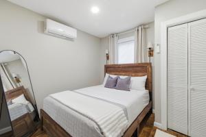 a bedroom with a bed and a mirror at Cozy Corner in East Stroudsburg