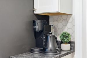 a kitchen counter with a coffee maker and a plant at Cozy Corner in East Stroudsburg