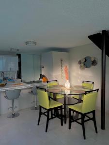 a kitchen with a dining room table and chairs at Modern 4BR Oasis in Bayamón