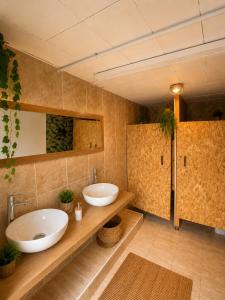a bathroom with two sinks and two mirrors at Pink lemon Galmping in Elche