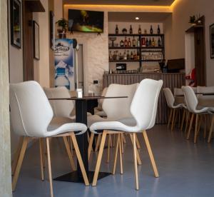 a group of white chairs sitting around a table at HOTEL LIBERTAS in Vlorë