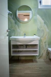 a bathroom with a white sink and a mirror at HOTEL LIBERTAS in Vlorë