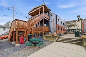 a wooden building with a staircase on a street at Cozy Corner in East Stroudsburg