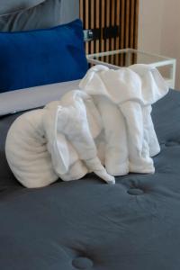 a stuffed elephant on top of a bed at PGD Blue city view in Rawai Beach +1 photo
