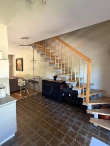 a living room with a staircase and a table at Poilsis Urbo Nidoje in Nida