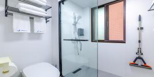 a bathroom with a glass shower stall and a toilet at Uffice apartment in Shanghai +170 photos