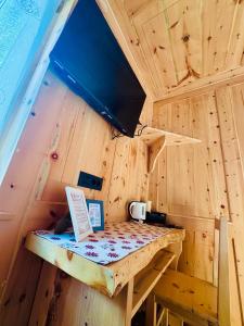 a tiny house with a table and a tv at La Gemma Bed & Breakfast in Montesover