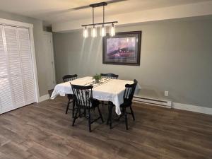 a dining room with a table with chairs and a painting at Thirty-Six Street Retreat in Missoula +3 photos