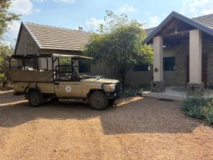 a jeep parked in front of a house at MANZINI RIVER HOUSE - Mjejane Private Game Reserve, Greater Kruger National Park in Hectorspruit