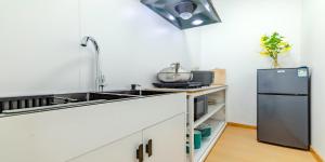 a kitchen with a sink and a refrigerator at Uffice apartment in Shanghai