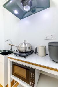 a kitchen with a pot on top of a stove at Uffice apartment in Shanghai