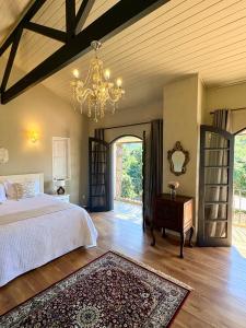 a bedroom with a bed and a chandelier at Pousada Casa Florinda in Teresópolis +74 photos