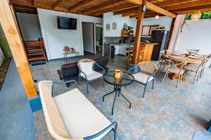 a living room with a table and chairs at Jacaranda House, rustic, Private Pool in Talamanca