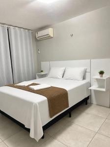 a bedroom with a large bed with white sheets at WaiWai Residence Cumbuco in Caucaia +18 photos