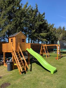 a playground with a slide and a play house at BananaHouse Junior in Kruszwin