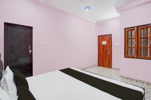 a room with a bed and a door at Hotel O Relax Inn in Lucknow