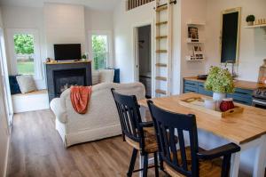a living room with a table and a couch at Blue Moon Bungalow in Tillsonburg