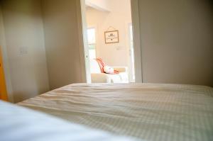 a bedroom with a bed and a chair at Blue Moon Bungalow in Tillsonburg
