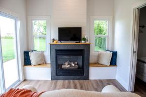a living room with a fireplace and a tv at Blue Moon Bungalow in Tillsonburg