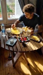 a man sitting at a table with plates of food at new colmbia in Cairo